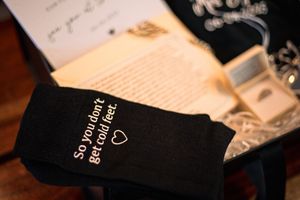 Black leather-bound religious books arranged on a dark wooden surface.