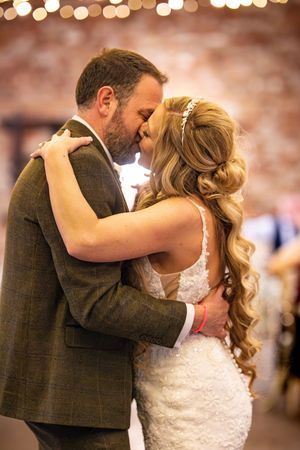 First dance sequence under warm lighting at wedding reception.