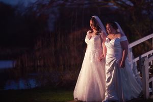 Wedding party silhouettes at dusk with dramatic lighting.
