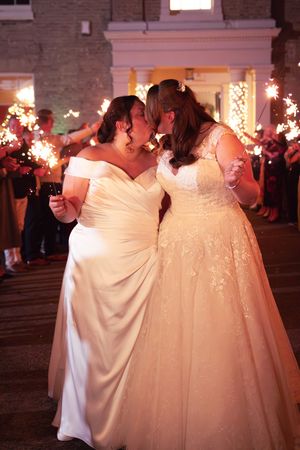 Wedding reception in a brick-walled venue with warm lighting and festive atmosphere.