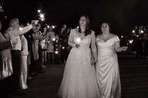 Wedding celebration at night with sparklers creating a magical atmosphere.