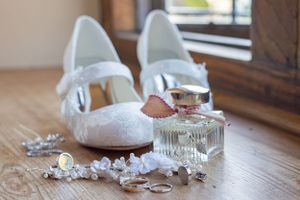 Broken pieces of white meringue scattered on a wooden table surface.