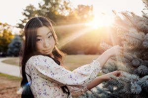 Dreamy sunset photoshoot featuring a delicate white lace dress and soft natural lighting.
