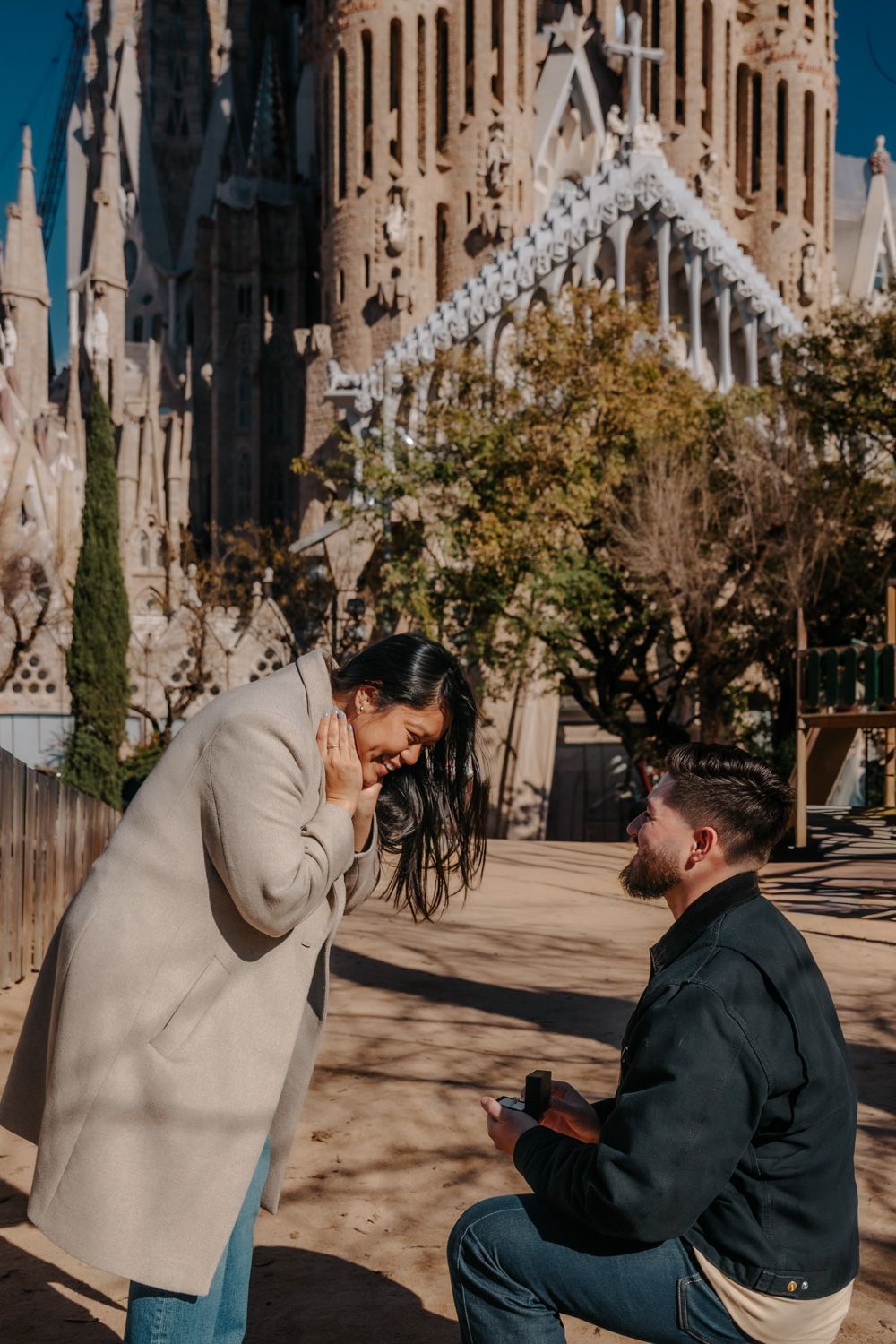 Looking back at each other while crowd blurs Sagrada Família Surprise proposal photoshoot Barcelona BarcelonaLoversPH