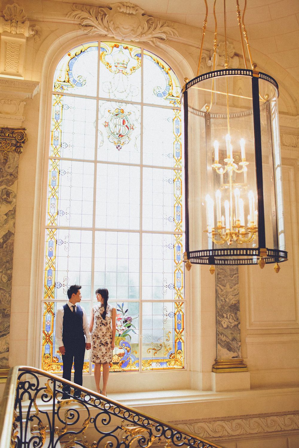 couple standing by grand window in historic European wedding venue at shangrila hotel in paris