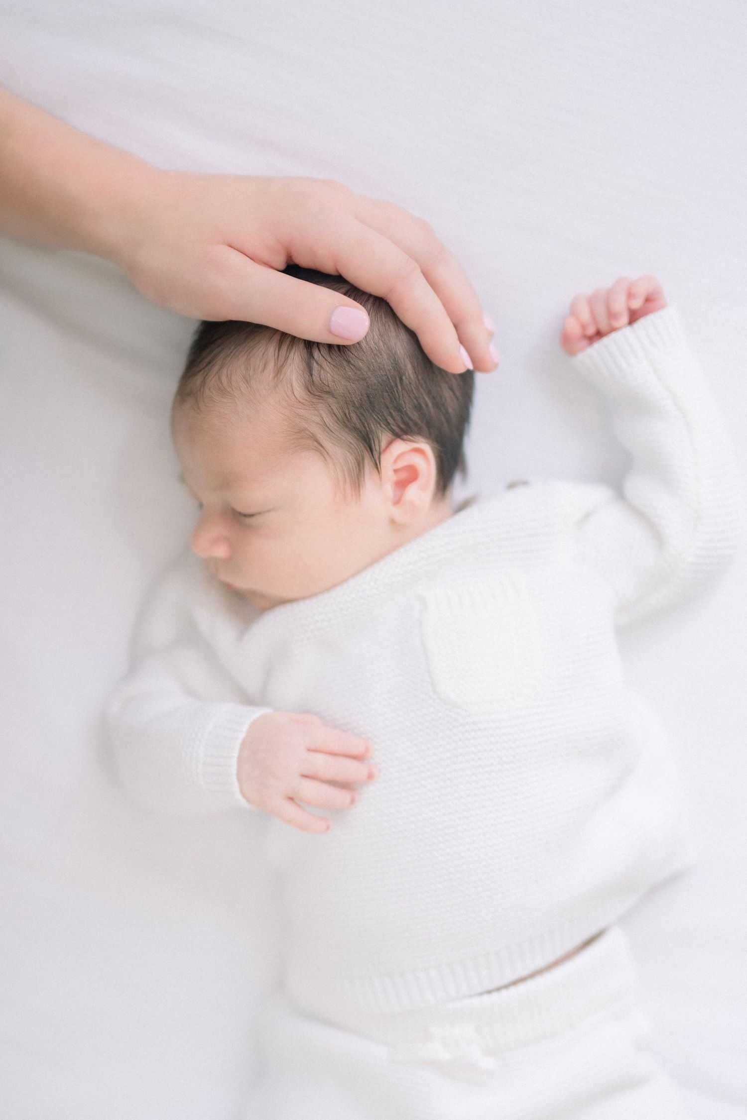newborn sleeping on white background at a newborn session in washington dc
