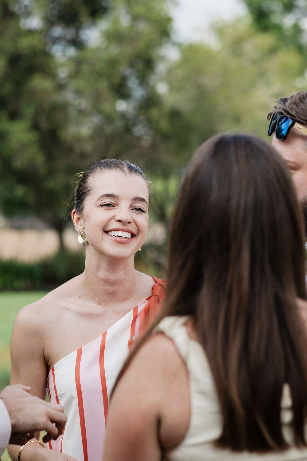 A series of candid photos showing two people sharing a joyful moment and laughing together outdoors in a natural setting.