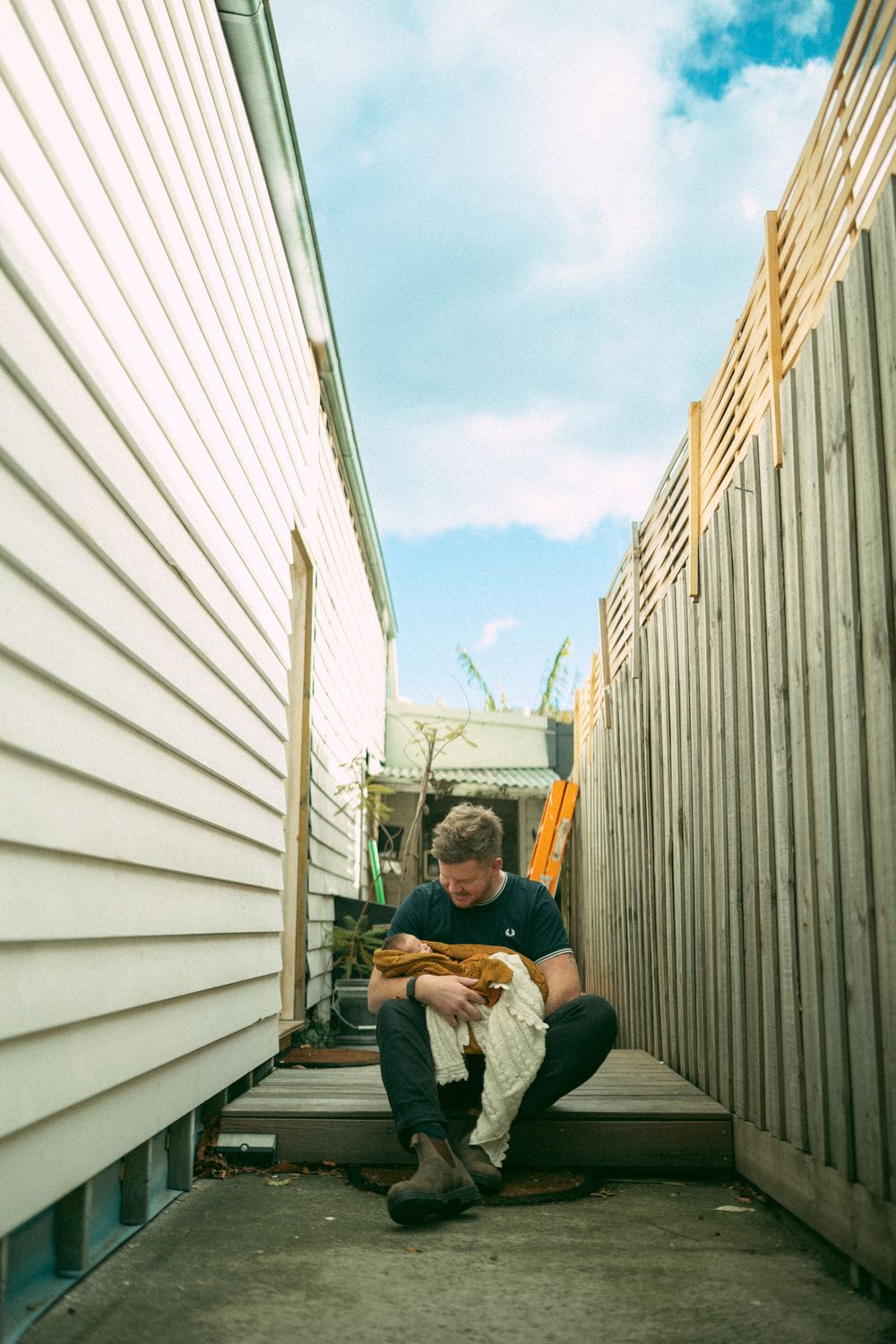 A series of photos showing someone lying on the ground between narrow walls in an artistic perspective shot.