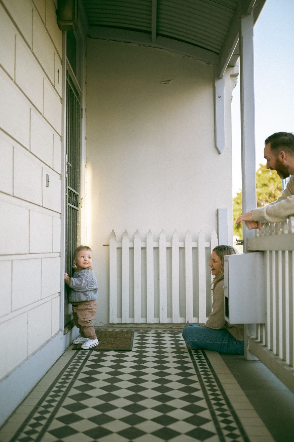 A sequence of four photos showing a child peeking around a white porch corner with a checkered floor pattern.
