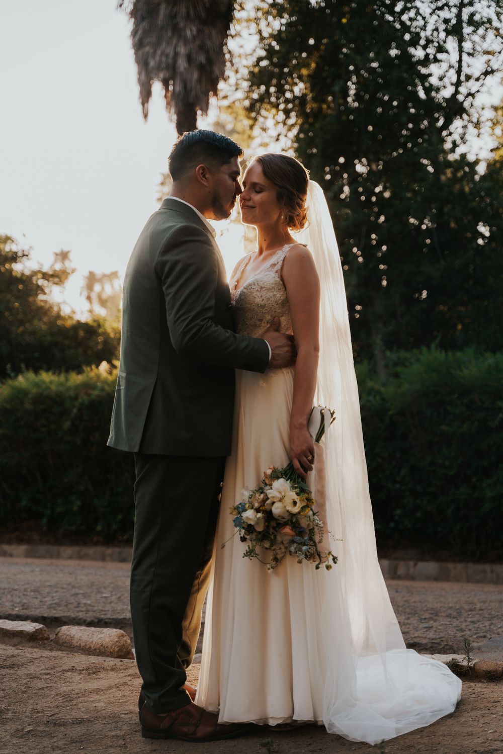 A romantic outdoor wedding photo series showing a couple in formal attire embracing during golden hour.