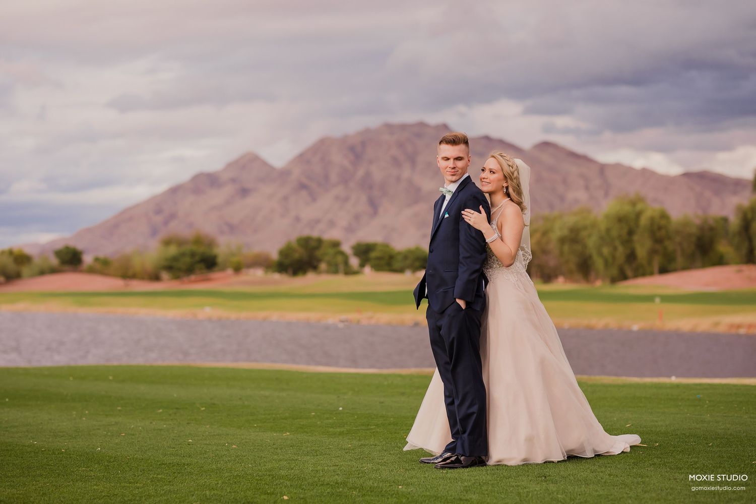 Black and white wedding photos showing a bride in a flowing white dress with a long veil in an elegant hallway setting.