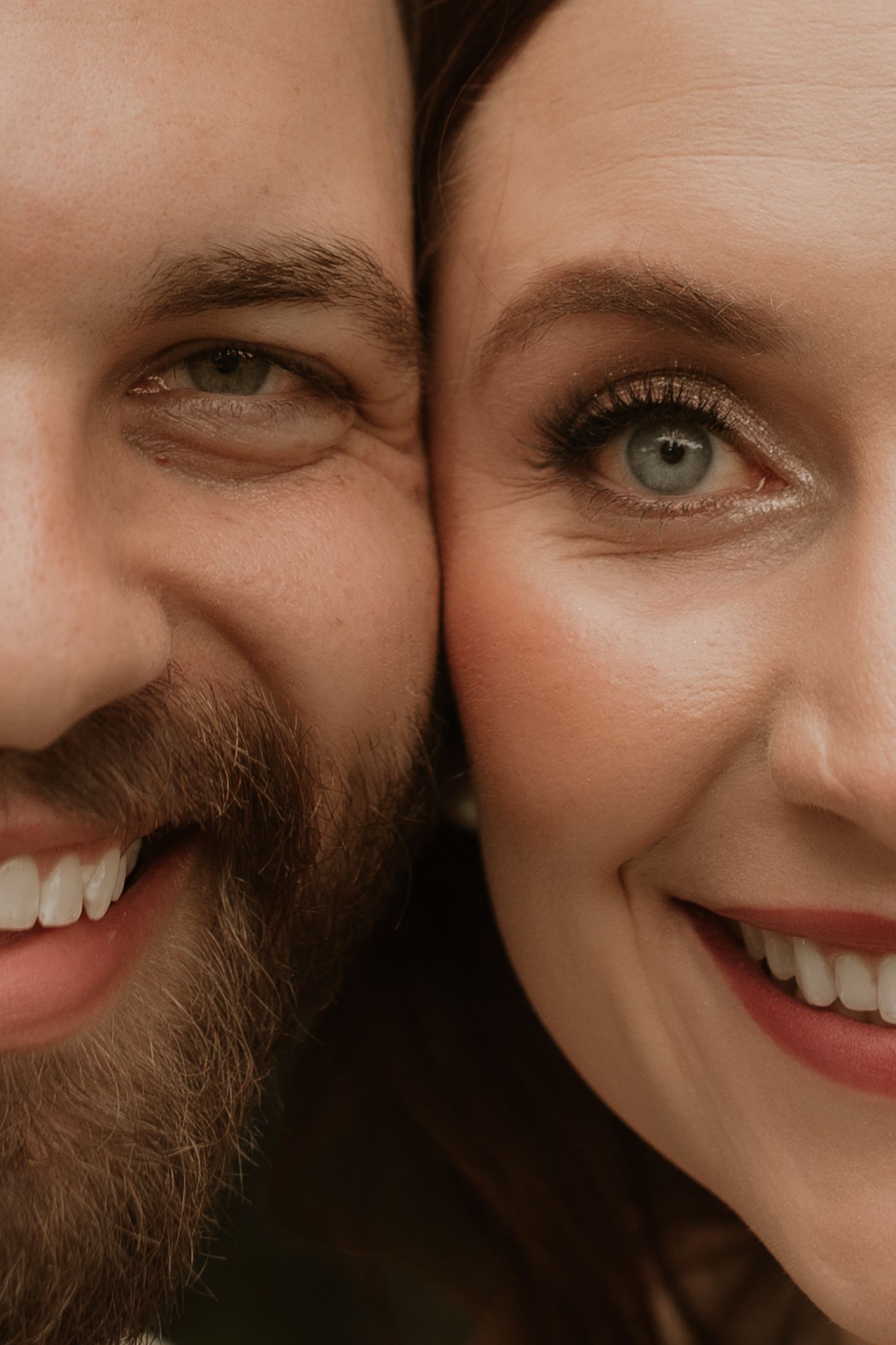 Close up details of smiling faces showing bright eyes and genuine joy.