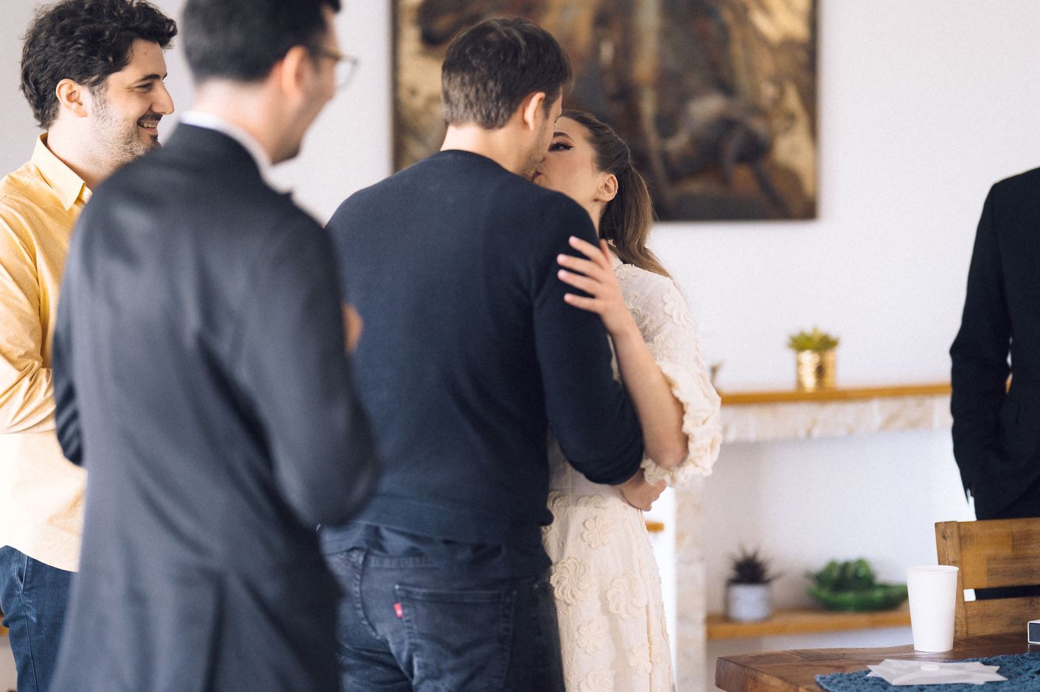 A couple shares an intimate moment during their wedding photoshoot in an elegant indoor venue.
