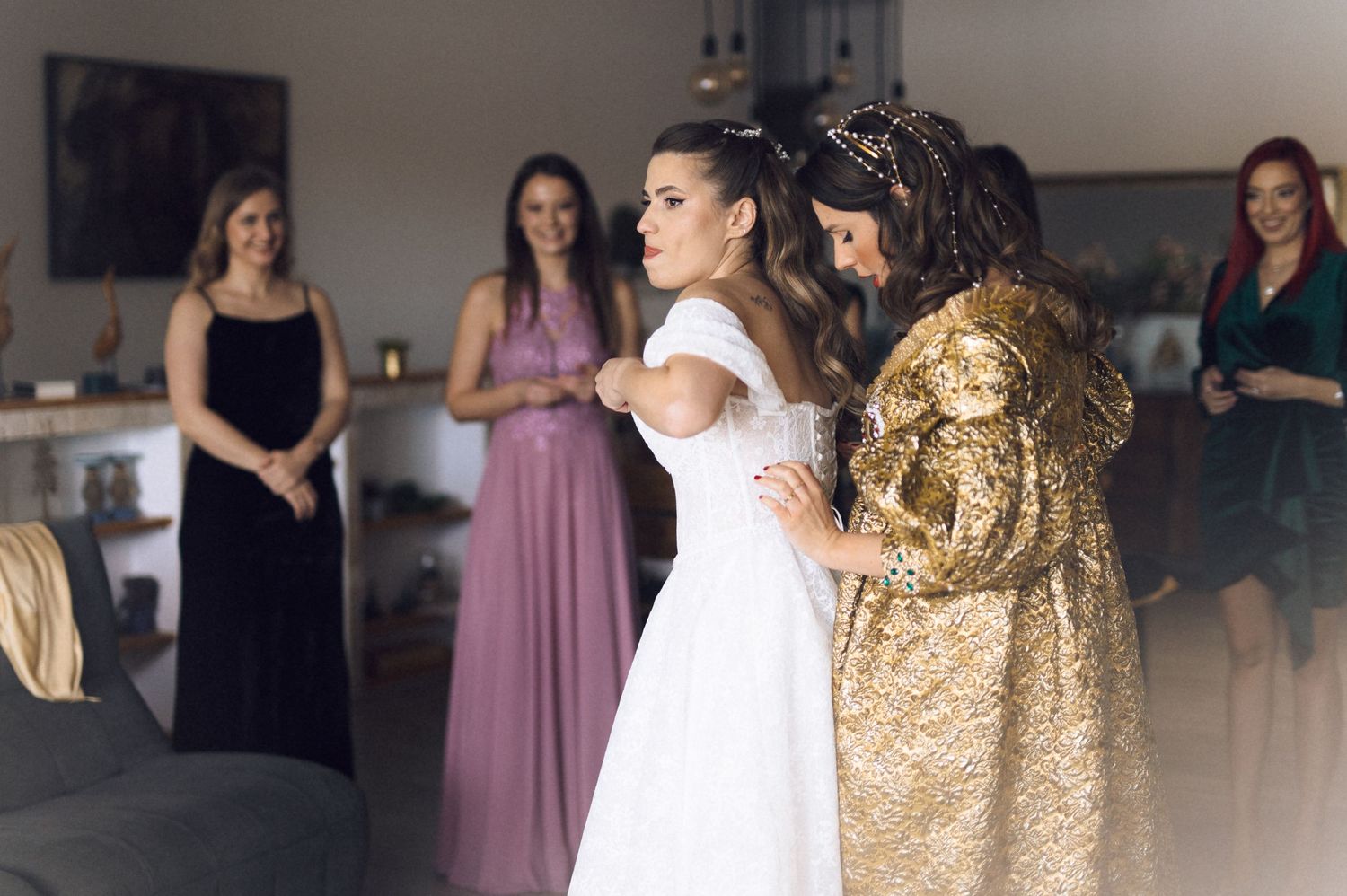 Wedding guests dance and celebrate on a reception dance floor in formal attire and evening gowns.