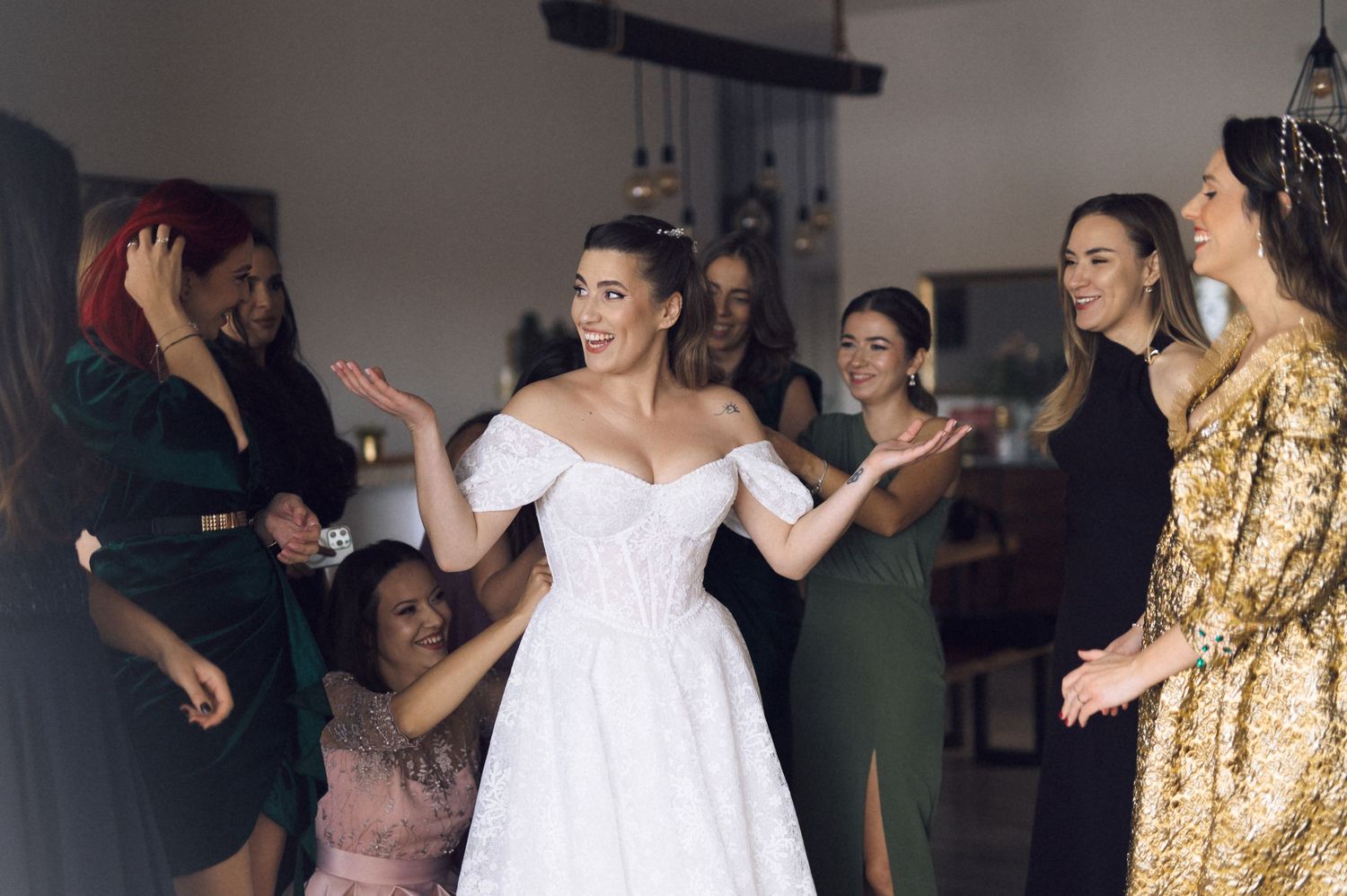 A group of wedding guests dance and celebrate together on the dance floor during a reception.