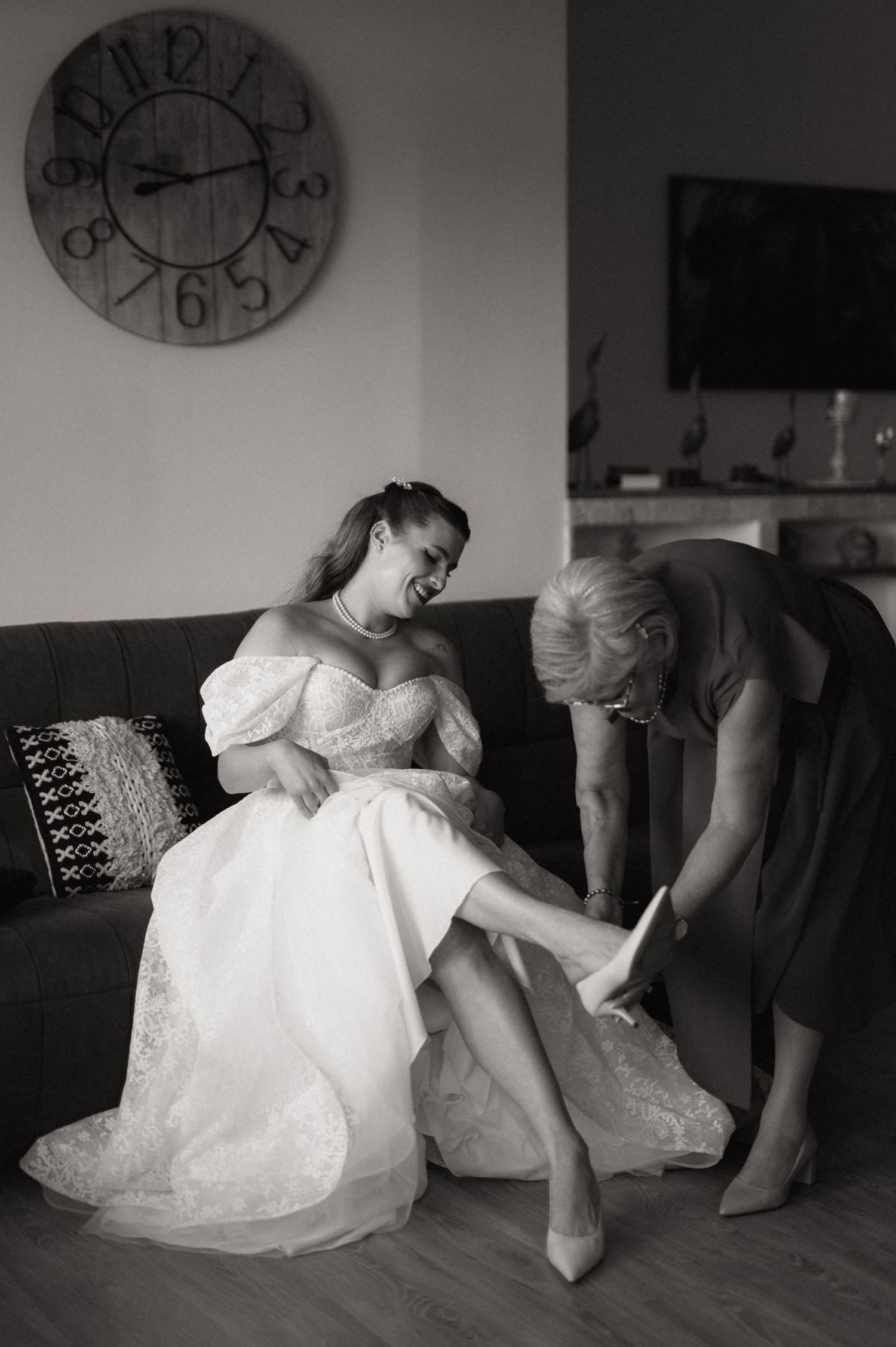 A figure in a white dress reclines on a sofa in a series of black and white photographs showing different resting poses.