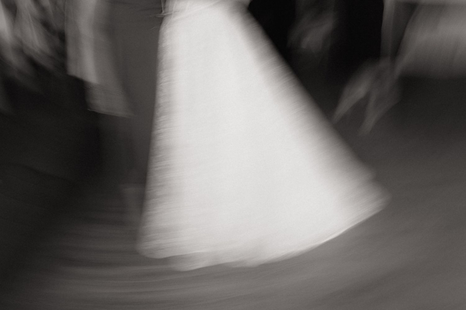 A series of black and white abstract photographs showing blurred light patterns and shadows.