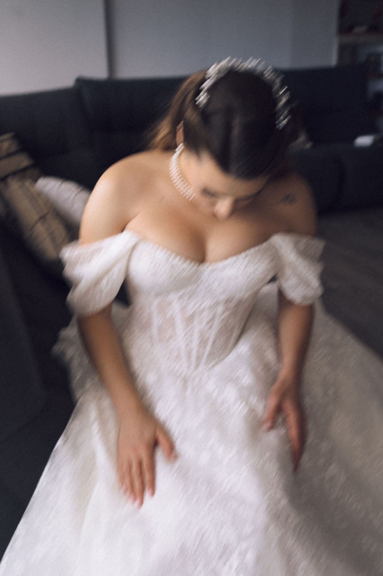 A white off-shoulder wedding dress with delicate lace details shown from different angles.