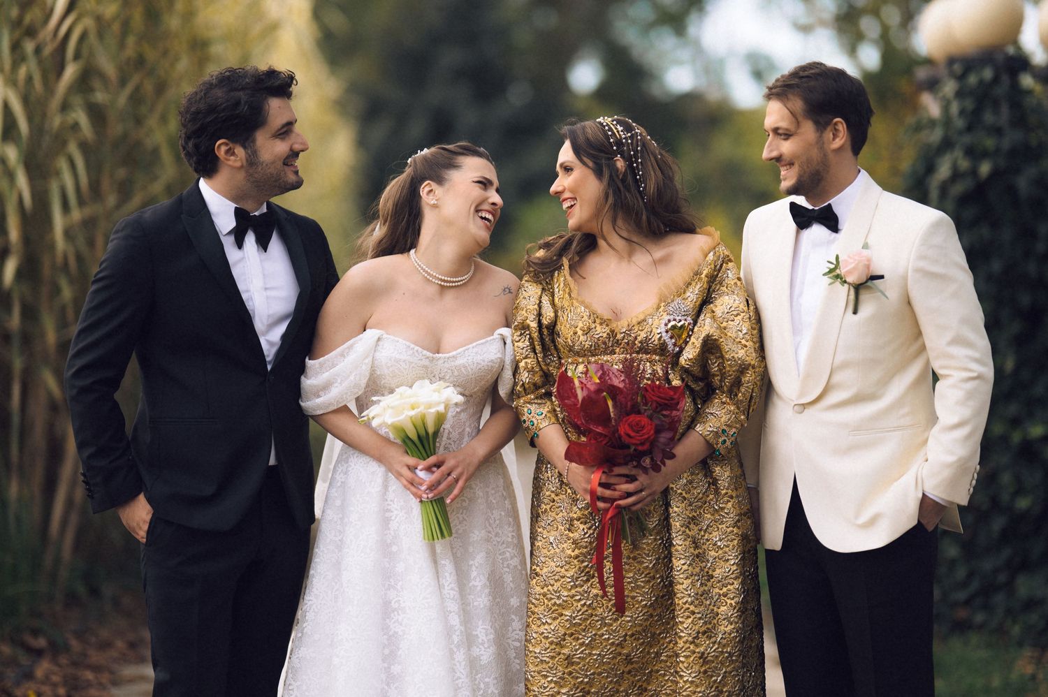 Couples in formal wedding attire share candid moments during an outdoor photo session at sunset.