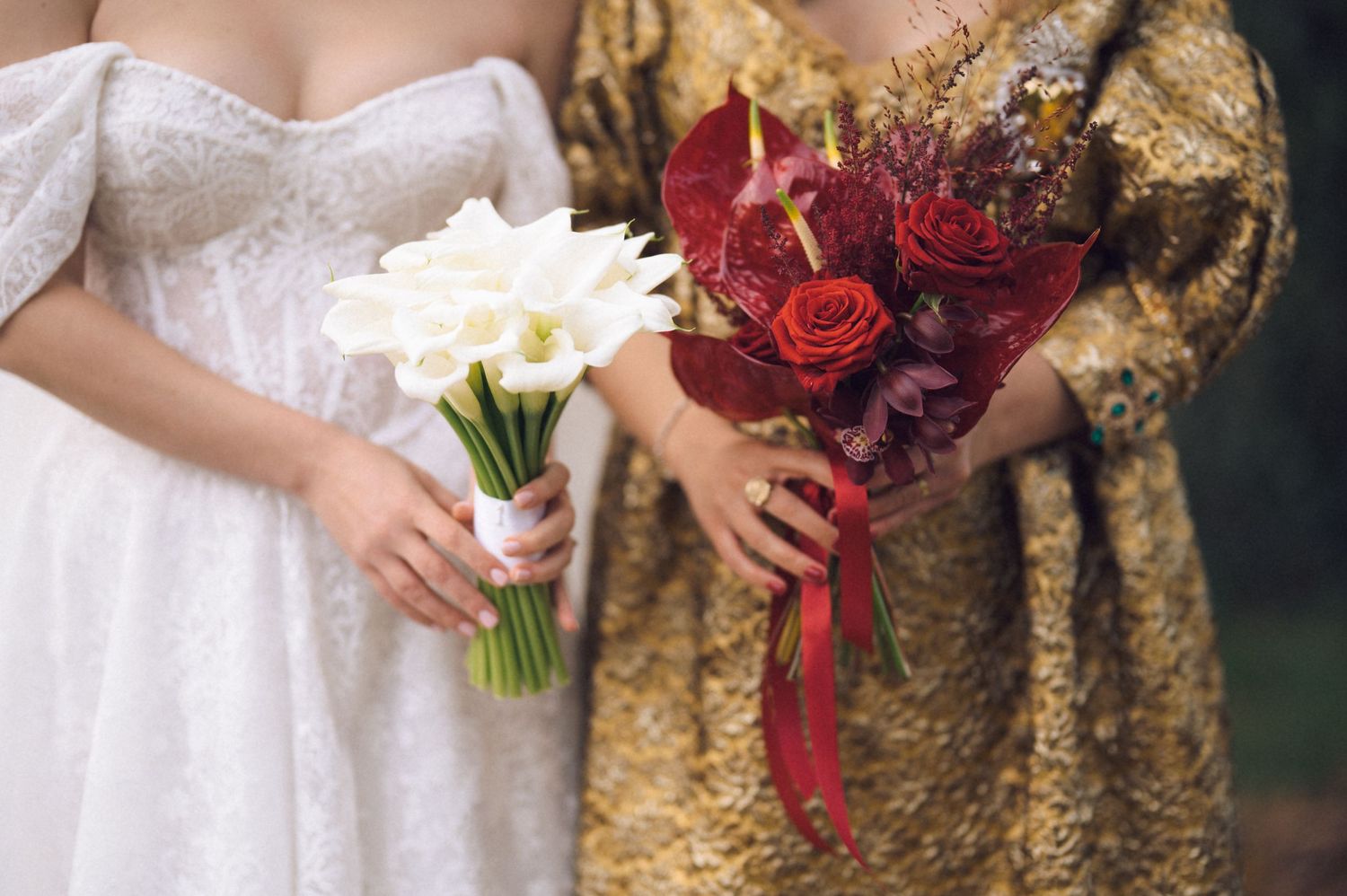 A row of bridesmaids holding colorful bouquets stand together in matching gold sequined dresses at a wedding.