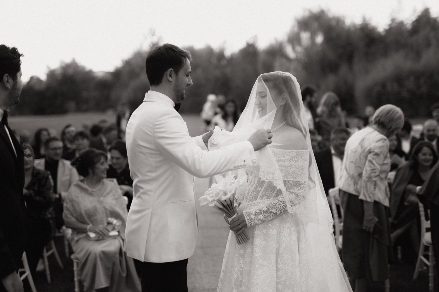A series of black and white wedding photos showing couples dancing and celebrating during an outdoor reception.