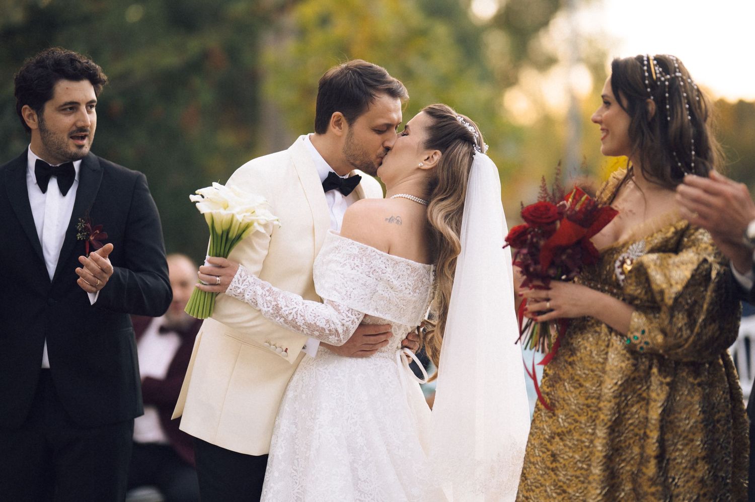 Romantic wedding couple shares intimate moments in outdoor garden setting during golden hour.