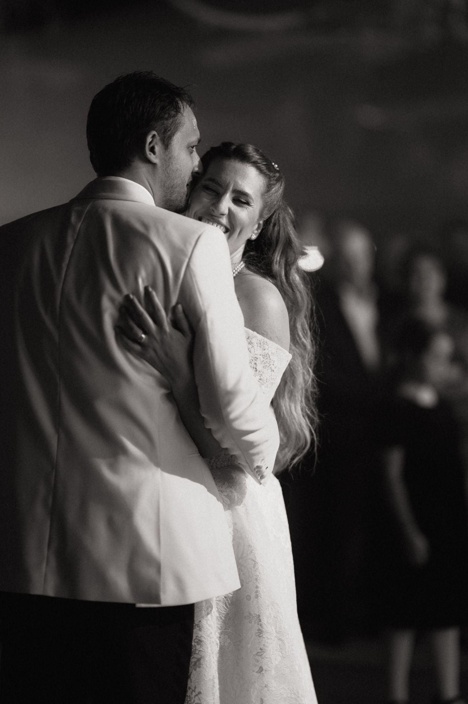 A black and white photo sequence shows a couple sharing their first dance at a wedding reception.