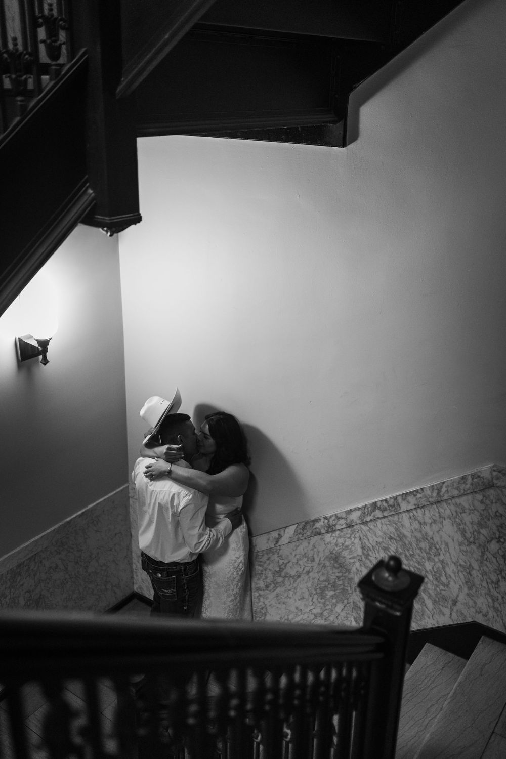 A dark and moody black and white photo sequence showing a figure curled up against a wall in dramatic lighting.