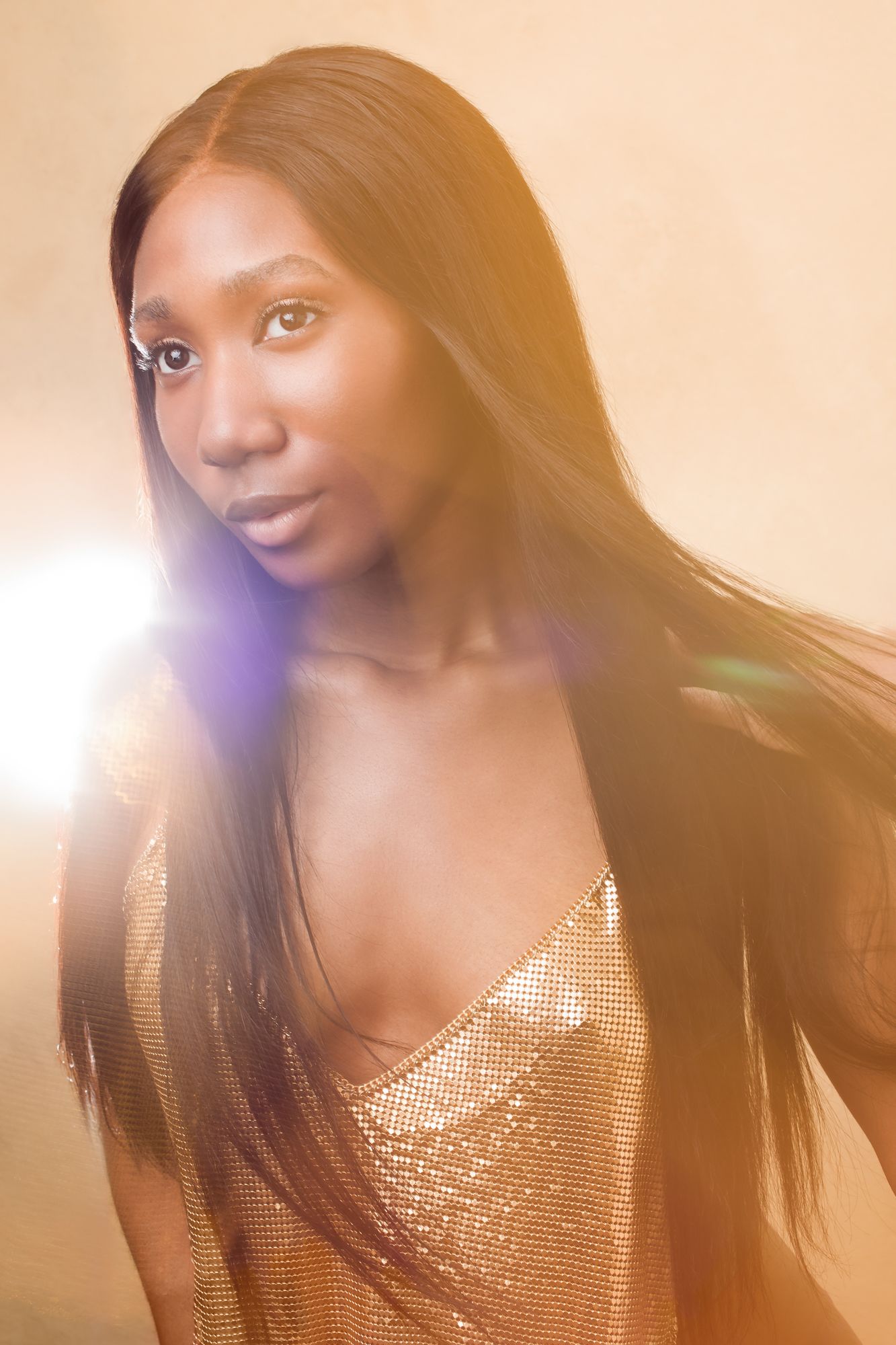 A sequence of photos shows a person in a sparkly gold top with flowing dark hair in warm lighting.