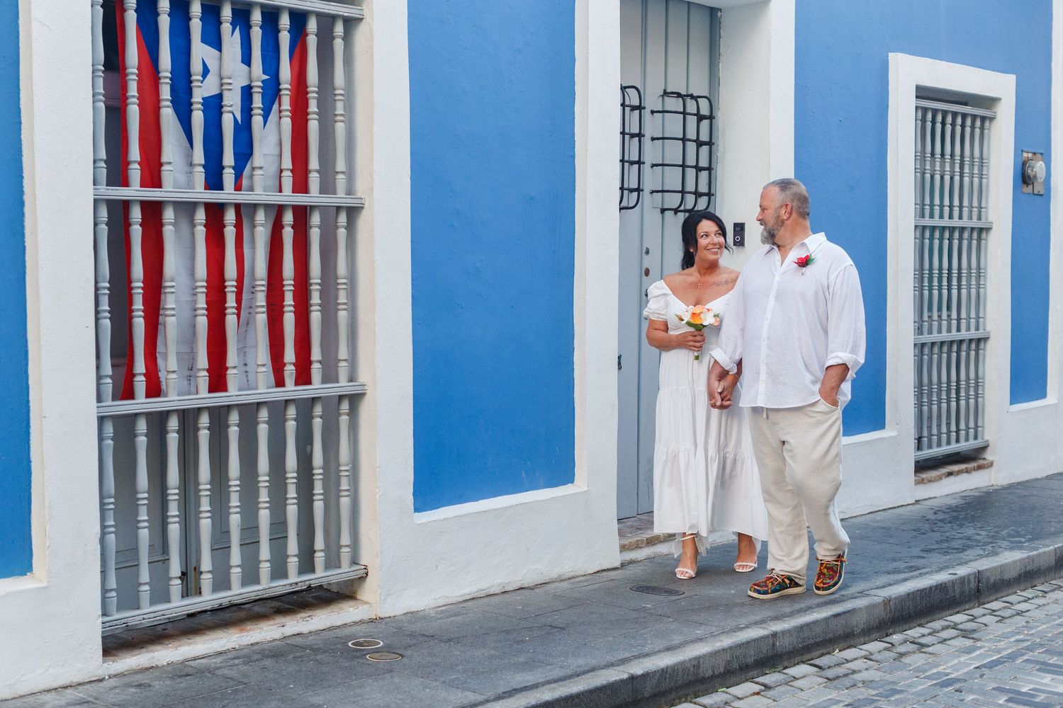 Wedding portrait. Couple walking along Calle de la Luna in Old San Juan, Puerto Rico.
