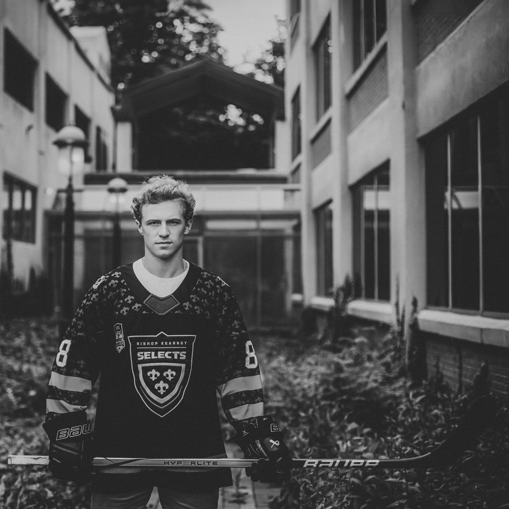 A series of black and white portraits showing a person in athletic uniforms against an architectural backdrop.