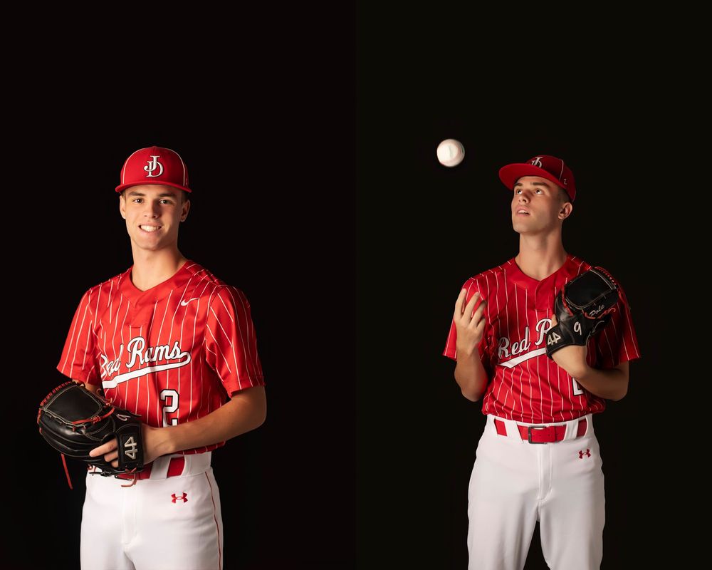 Baseball player in red Philadelphia Phillies uniform throwing a pitch against dark background.