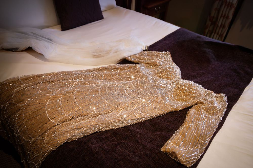 Detailed embroidery work showing intricate gold thread patterns on dark fabric with multiple close-up views.