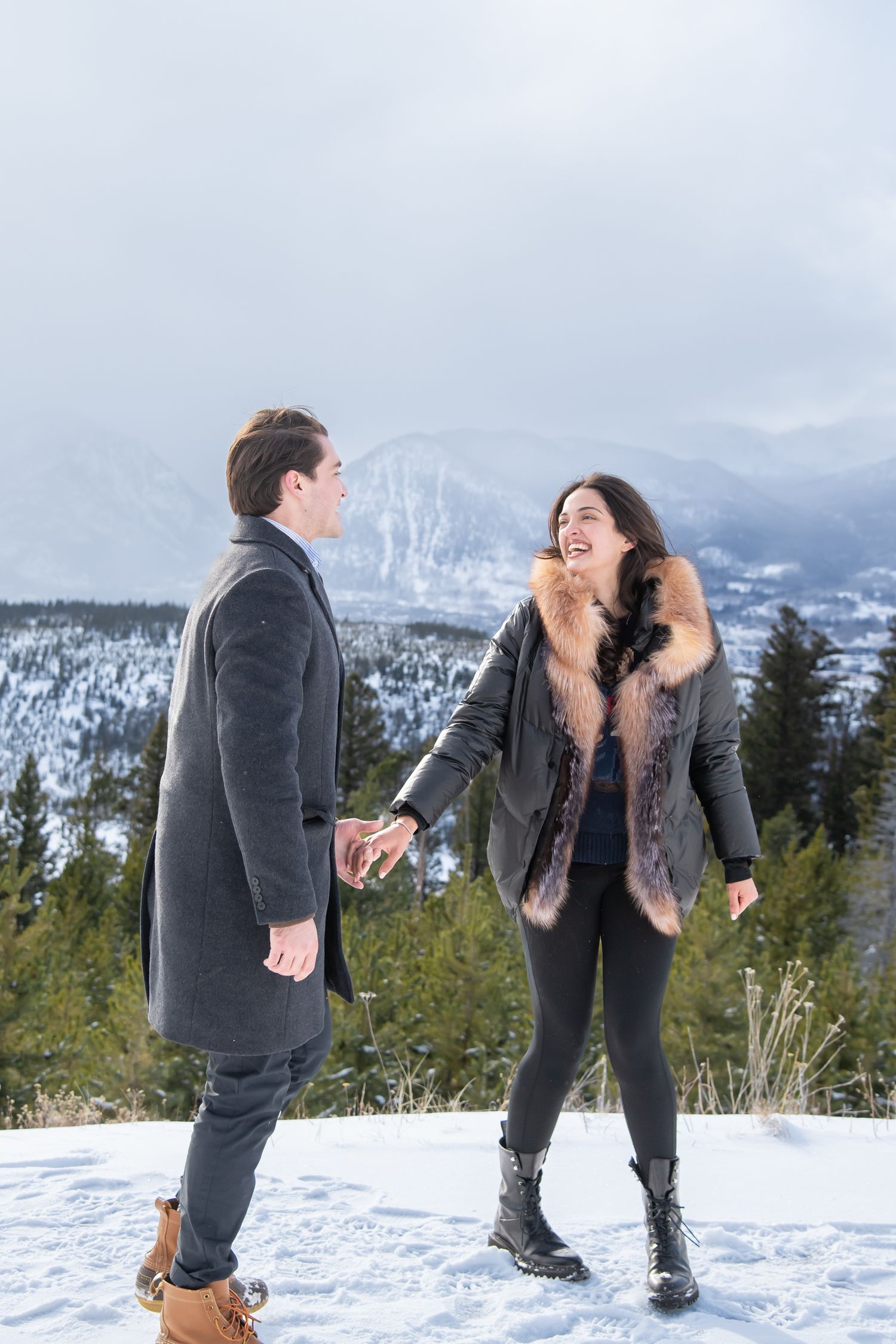Candid laughter during a winter engagement photo session in Breckenridge Colorado.