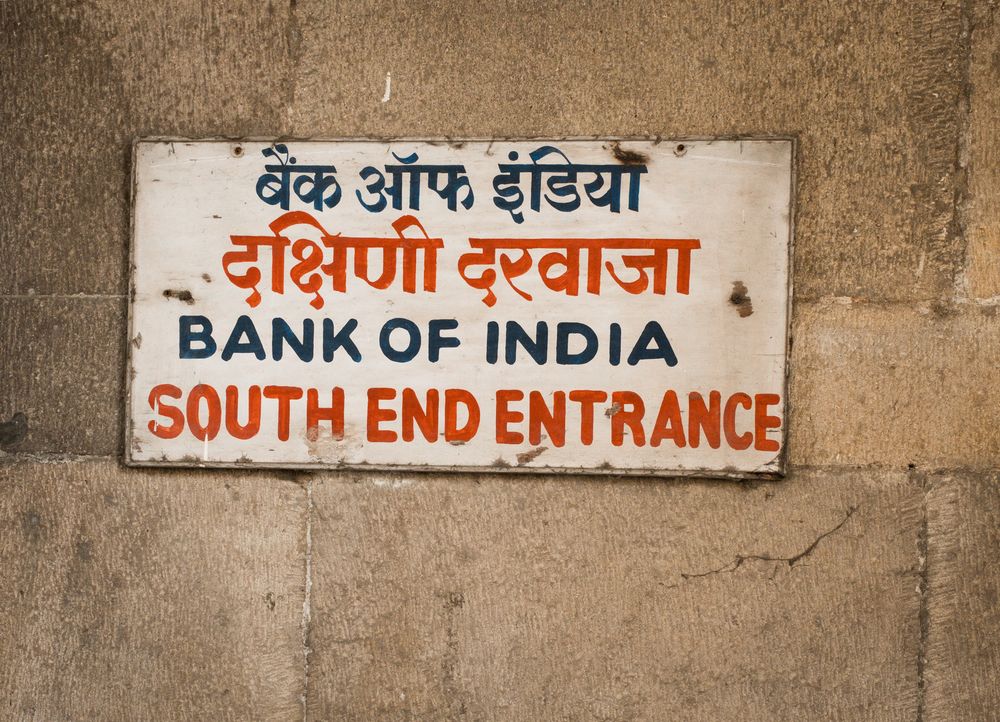 Bank of India South End Entrance sign in English and Hindi on a stone wall in Mumbai.