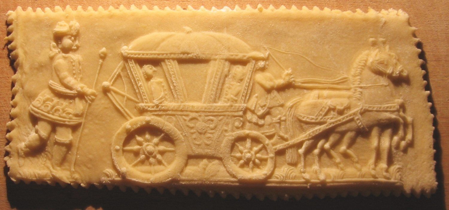 Ancient Roman relief carving shows a horse-drawn carriage with figures in a classical transportation scene.