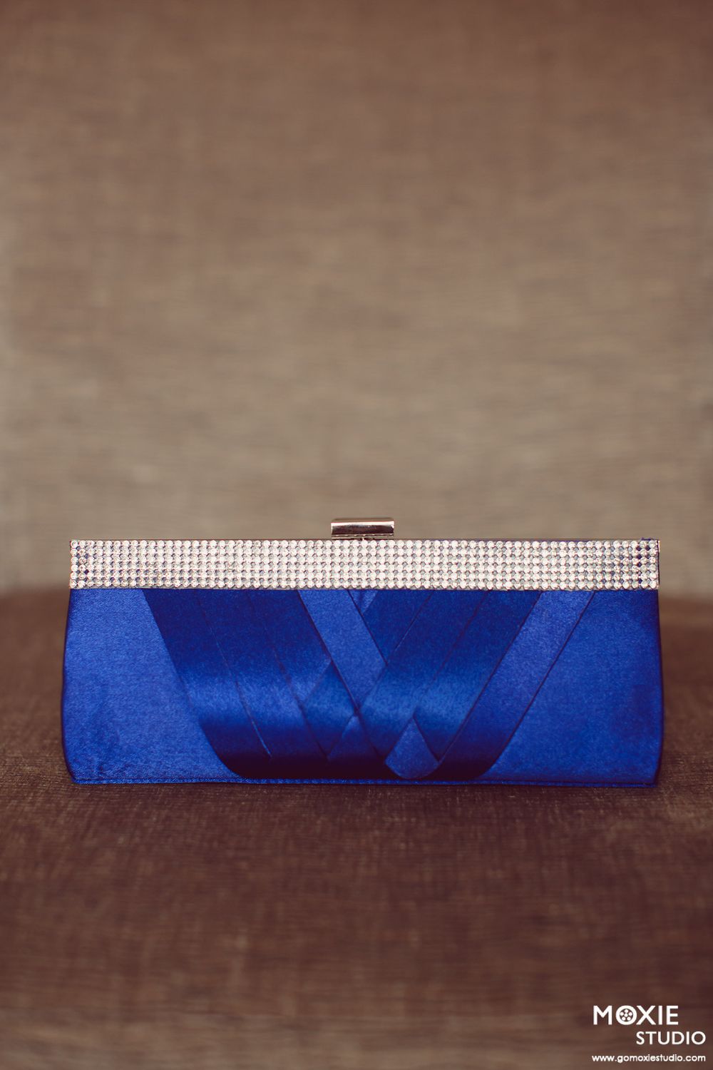 A series of images showing the step-by-step process of folding a blue napkin into an elegant geometric shape.