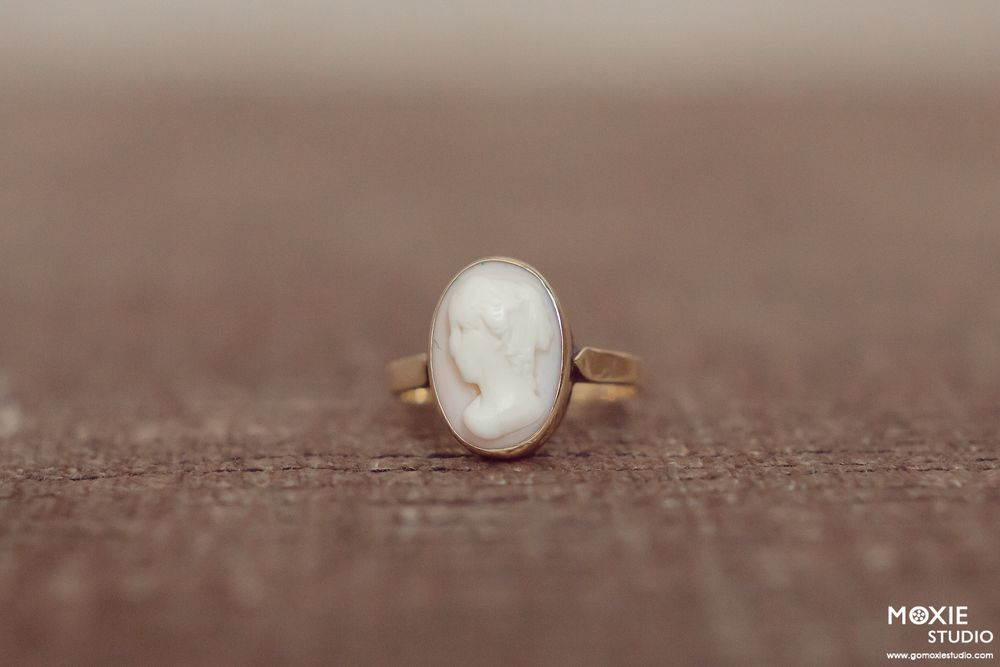 A delicate gold ring with a pearl stone shown in a sequence of macro shots against a brown textured background.