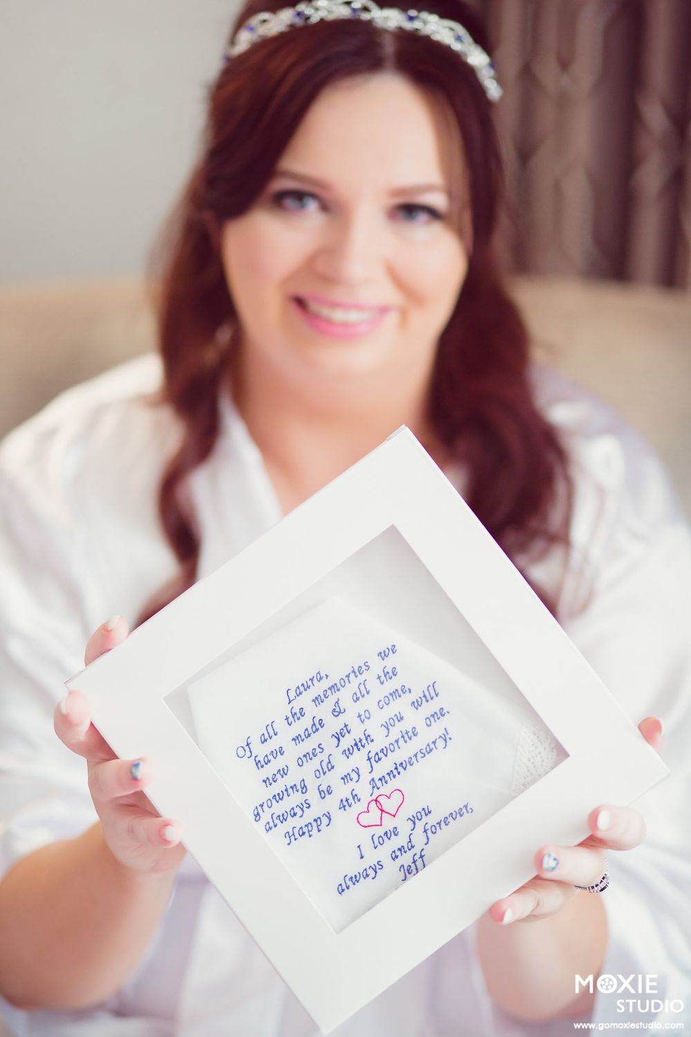 Woman in white holding handwritten notes showing wedding day messages and details.