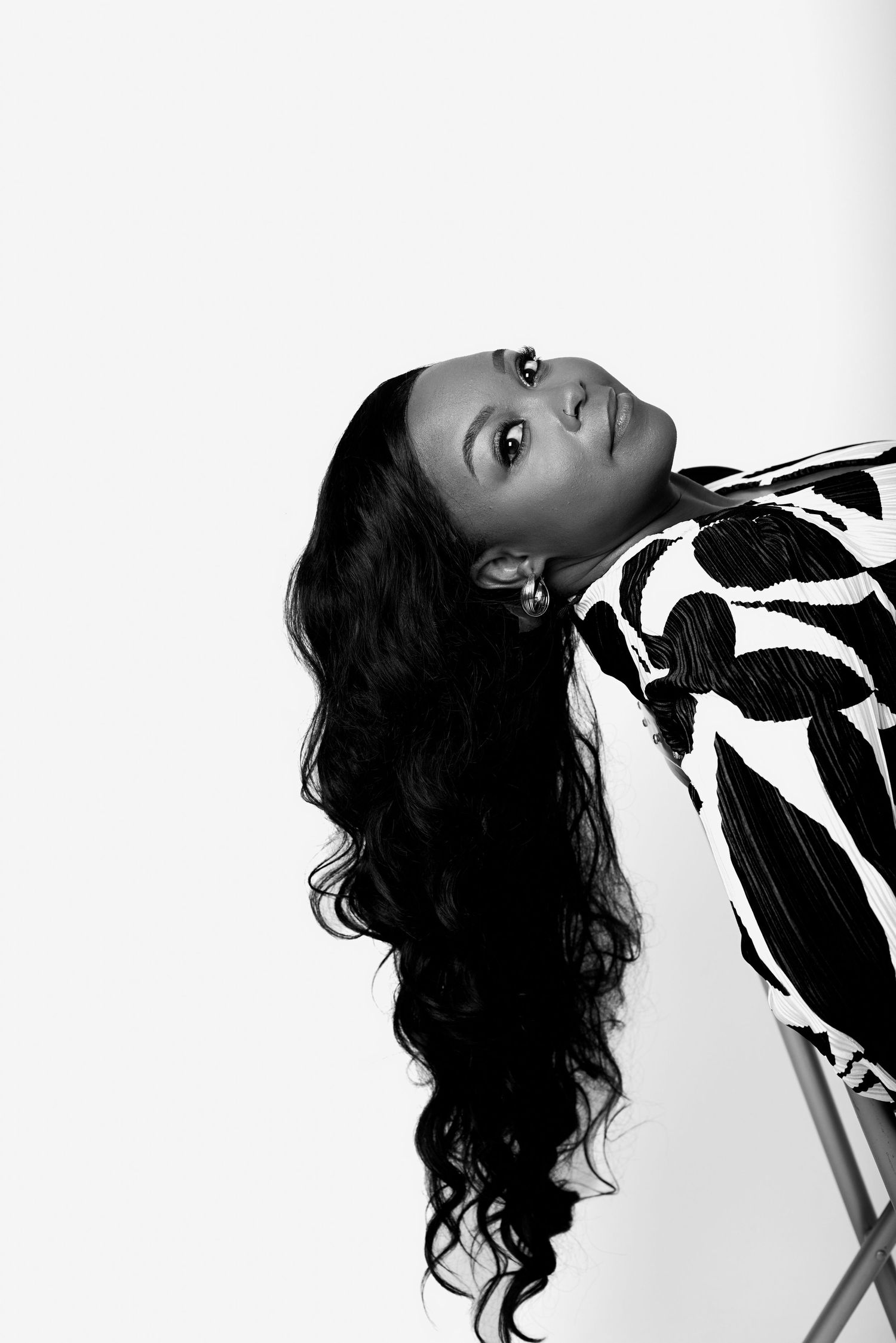 Black and white artistic portrait series showing dramatic poses against white background.