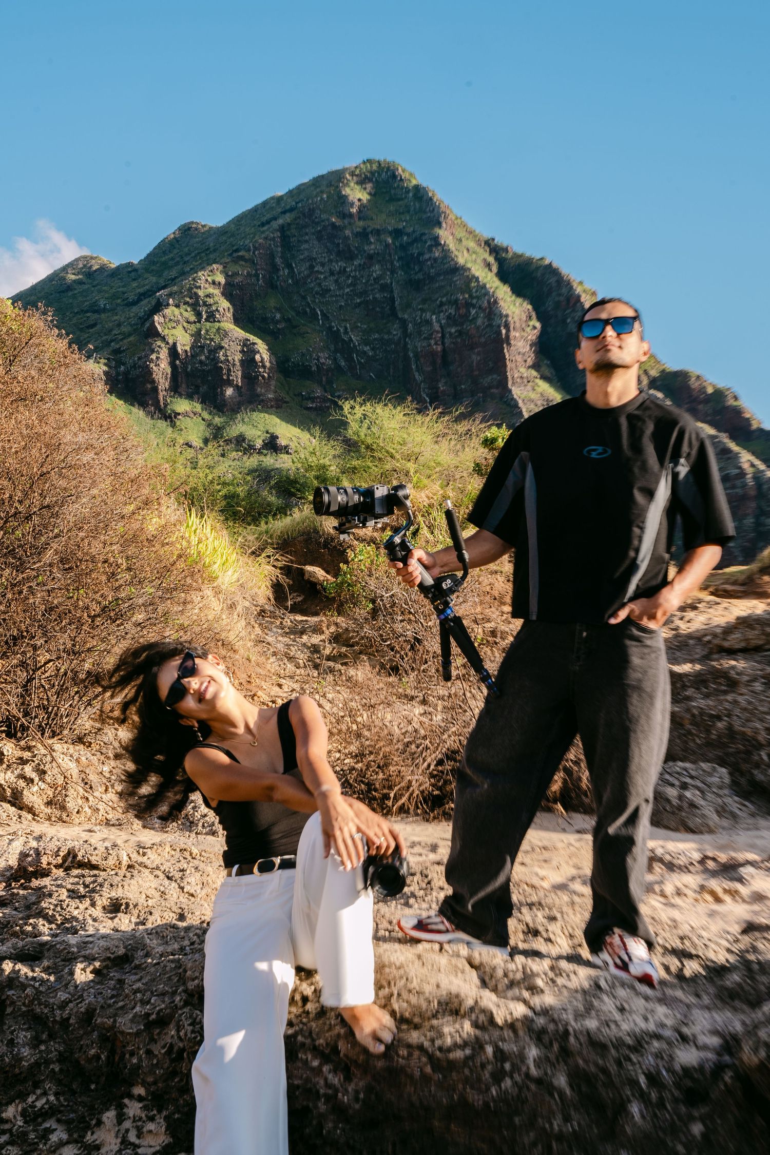 A series of candid engagement photos showing a couple posing against a scenic mountain backdrop in Hawaii.