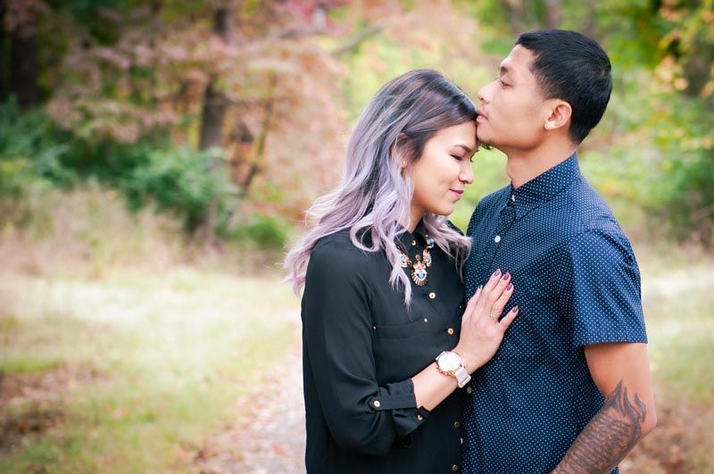Intimate couple portraits captured during golden hour in a natural outdoor setting.