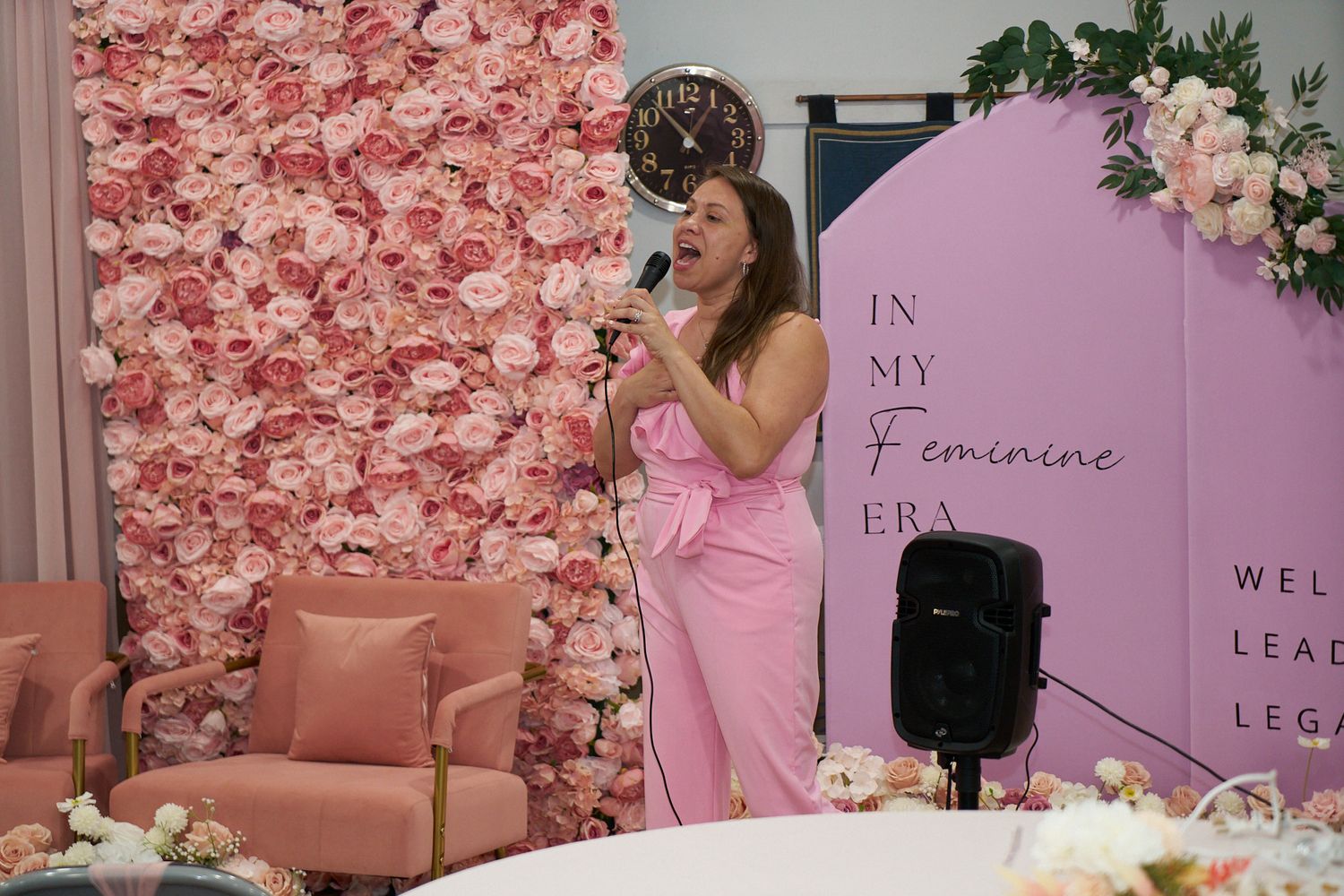 Speaker at a local women's event with elegant feminine event space with blush accents.
