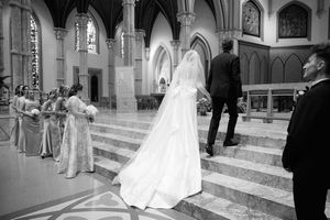 A series of black and white wedding photos showing couples walking down church aisles and cathedral steps.