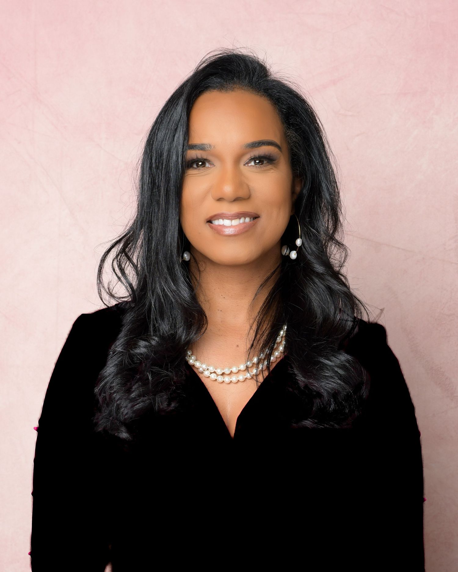 Professional portrait series showing confident woman in black blazer against pink background with various poses and expressions.