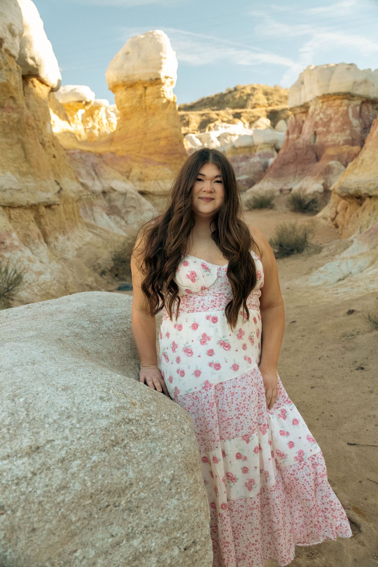 A row of legs and feet showing couples dancing together on a dirt surface in casual western attire.