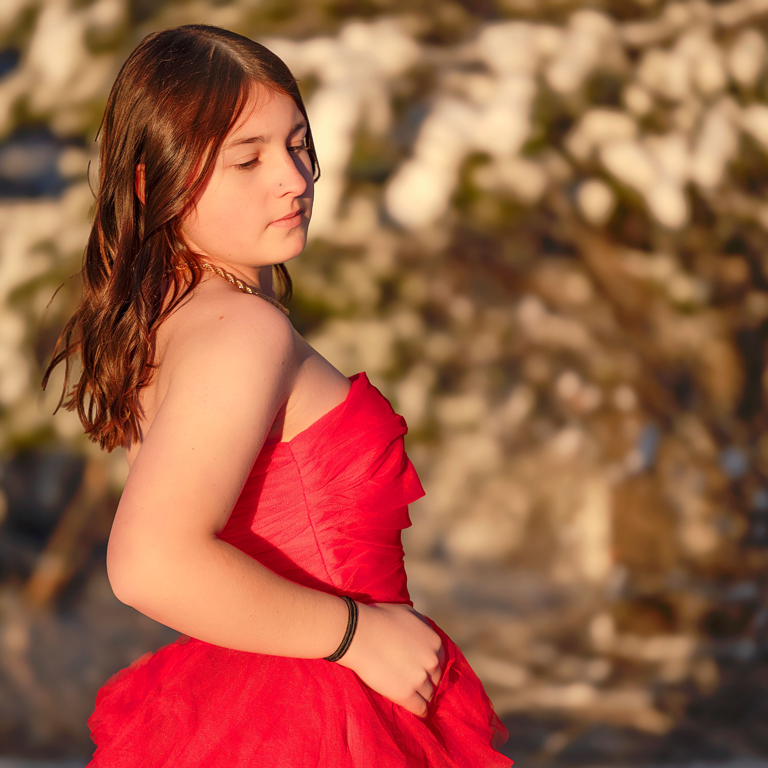 A series of outdoor portrait photos showing someone in a flowing red dress against a natural backdrop.