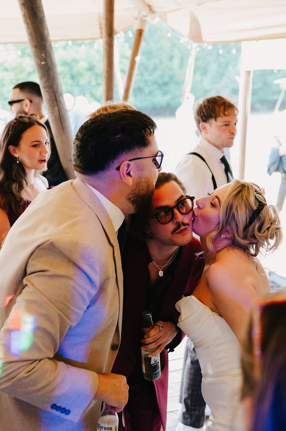 A series of romantic moments captured at a wedding reception as couples share intimate kisses on the dance floor.