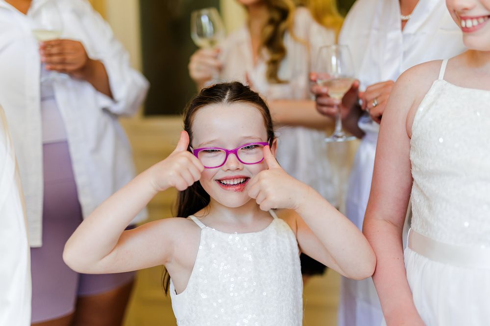 A group of people wearing white outfits gather together at a celebration event.