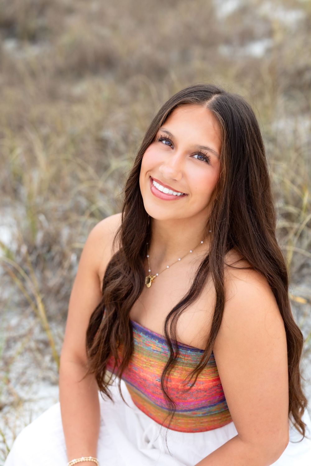 A series of five portraits of a young woman with dark hair in a colorful striped top posing outdoors in a snowy setting.